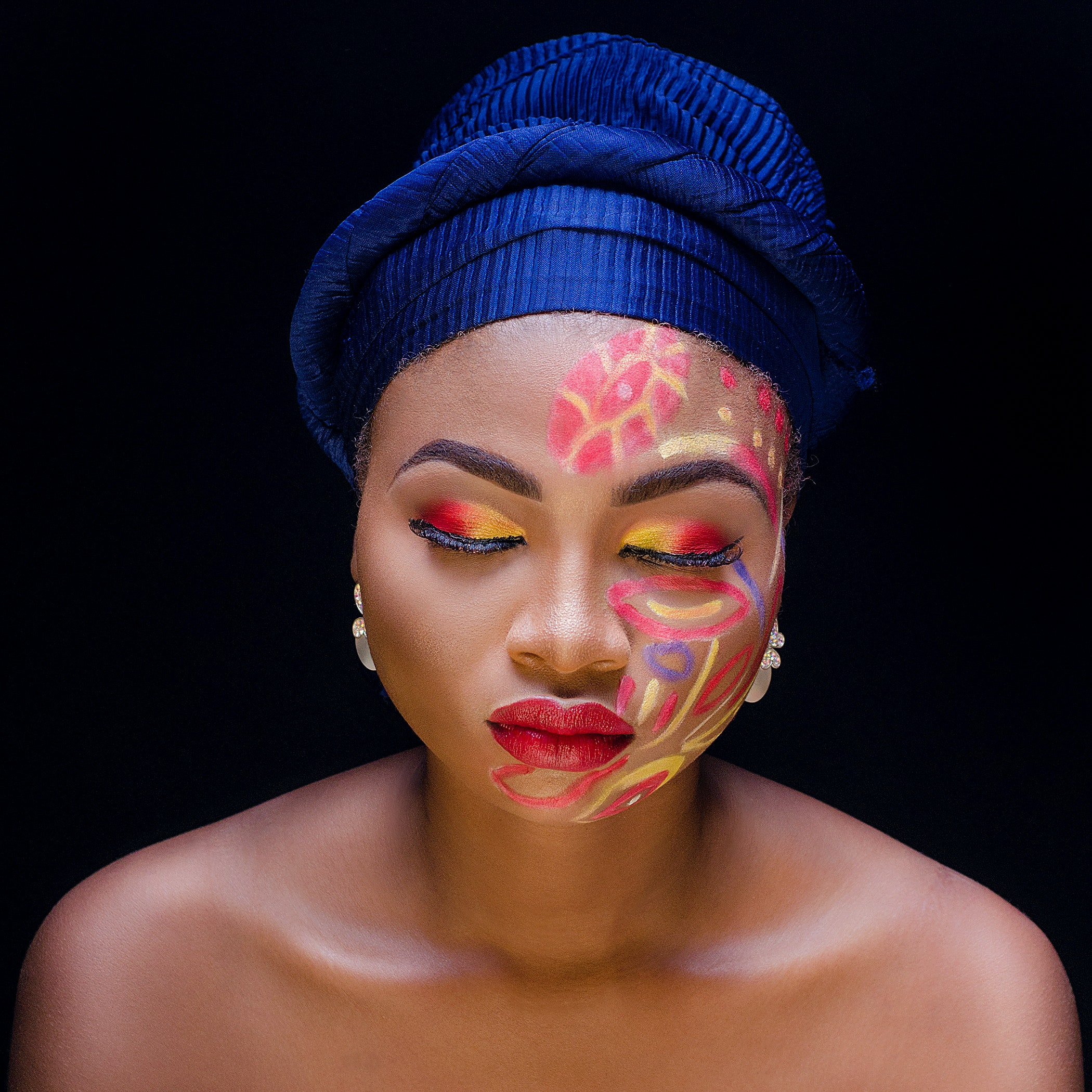 woman with face painted and blue hat