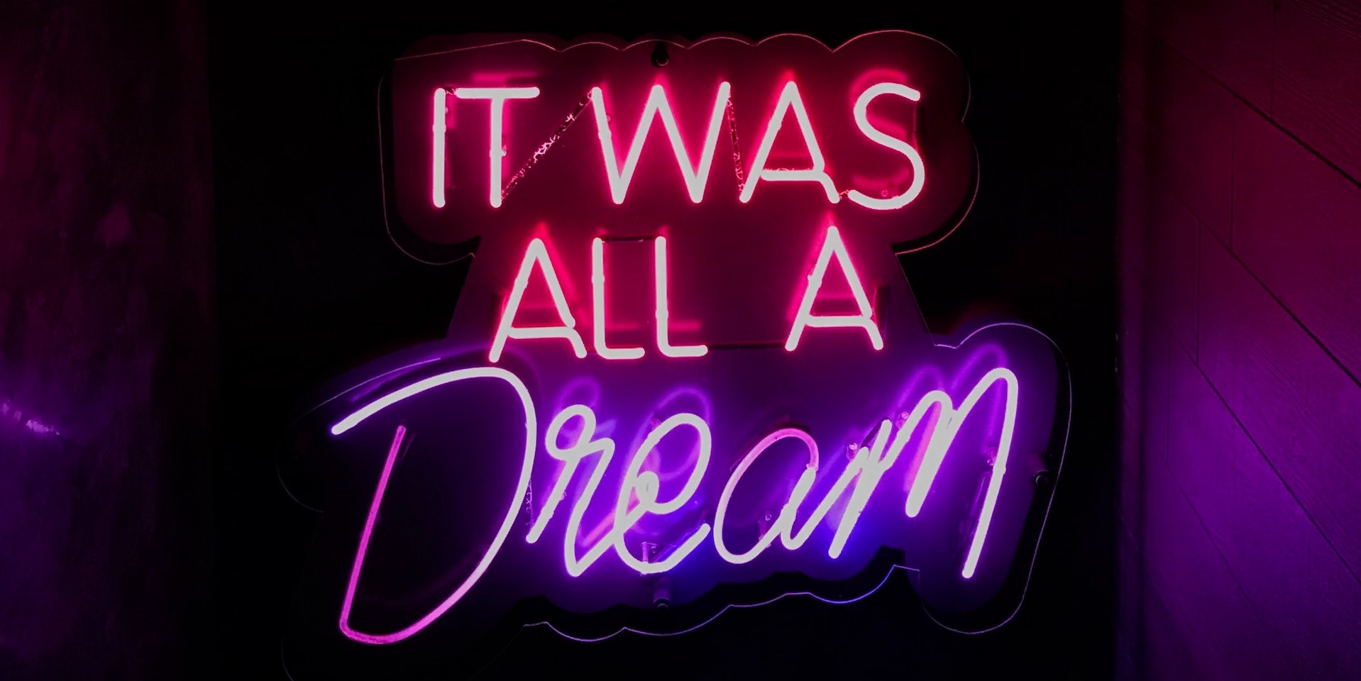 pink and purple neon sign that says it was all a dream