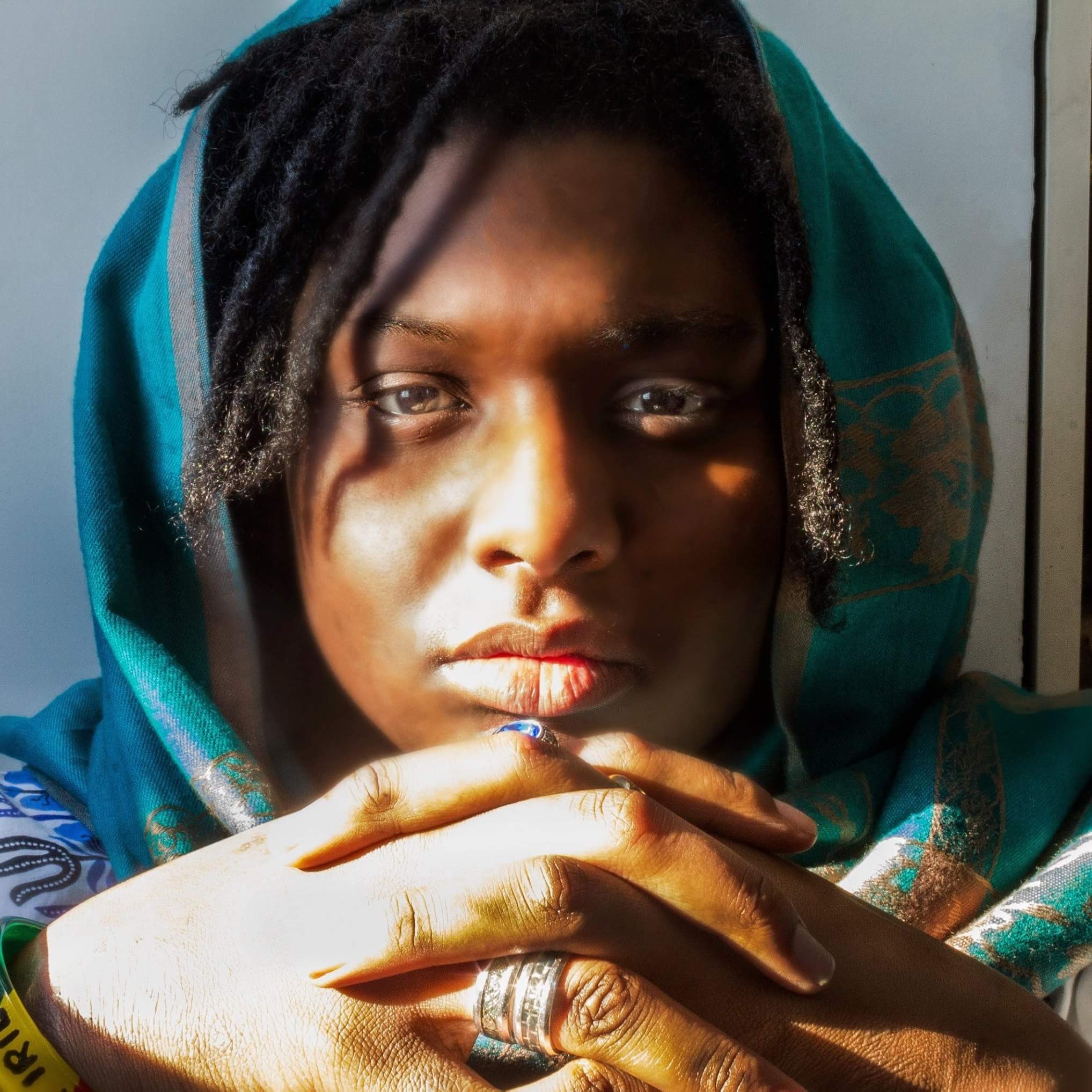 woman with dreads and head scarf